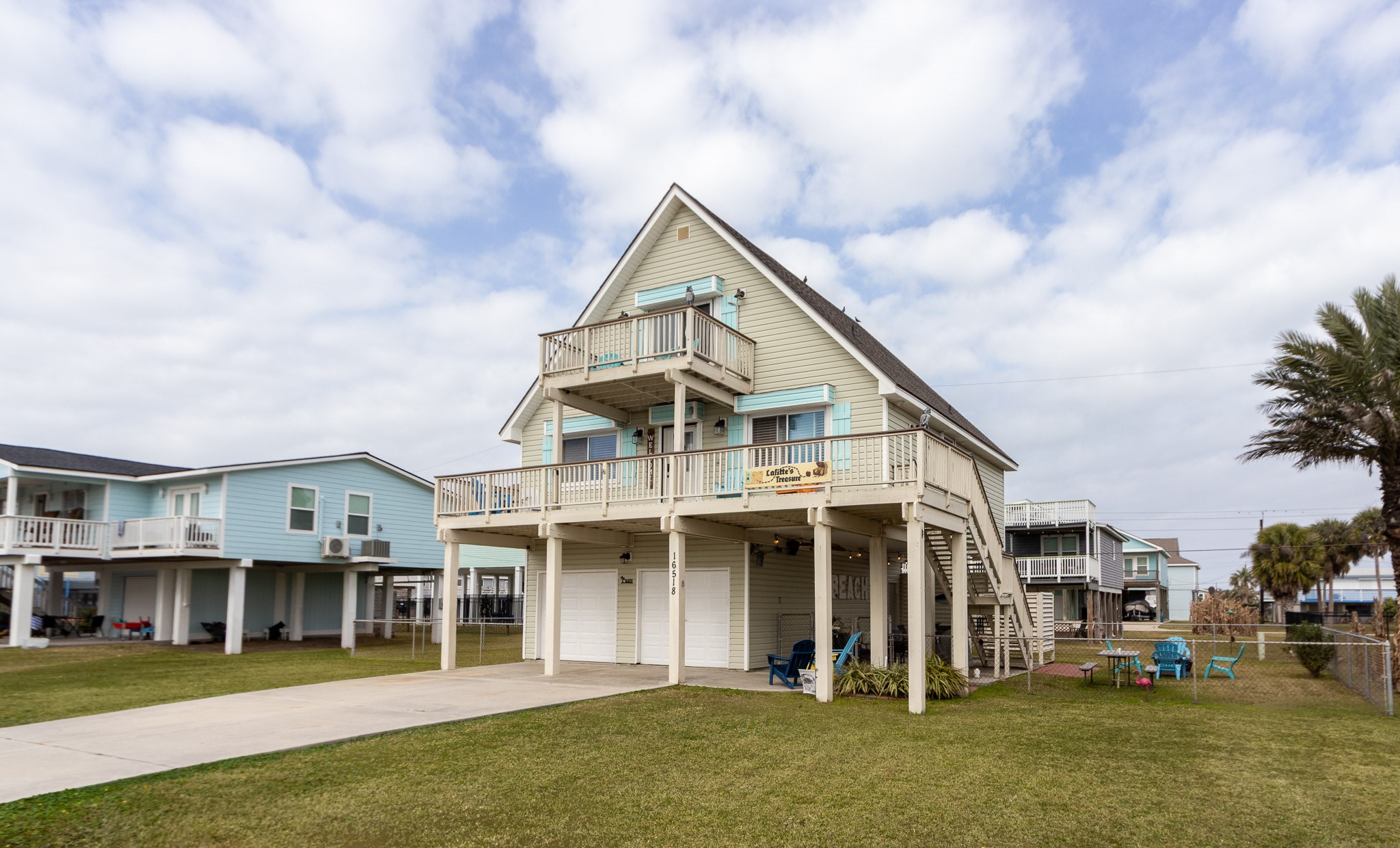 16518 Jean Lafitte Road Jamaica Beach, TX 77554 - Photo 43 of 43 a view of a large white building next to a yard