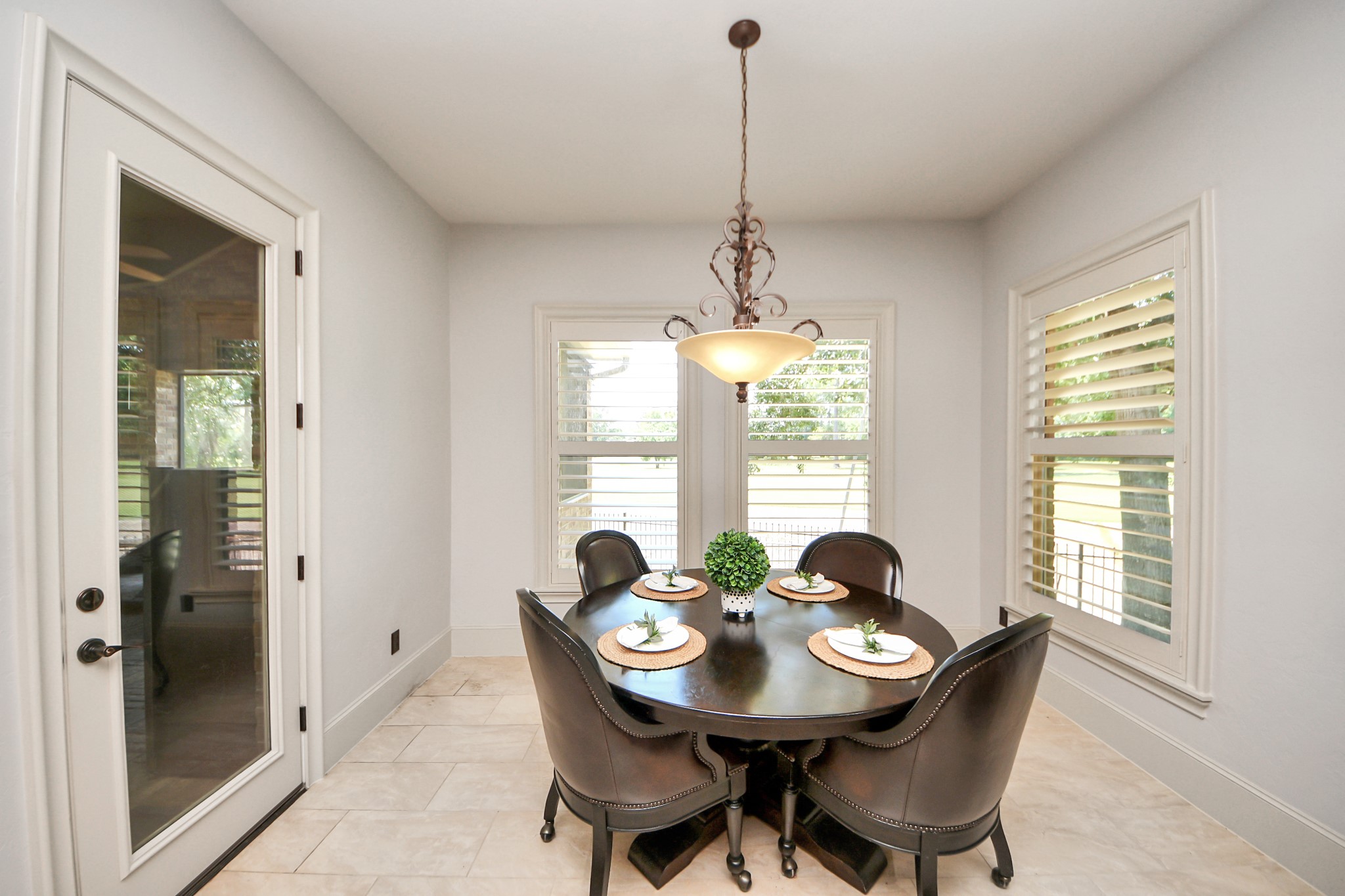 702 Fairway Oaks Conroe, TX 77302 - Photo 17 of 42 This bright breakfast nook
features large windows with
plantation shutters allowing
natural light, and a stylish
pendant light overhead.