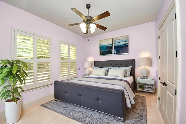 a bed room with a bed and a large window