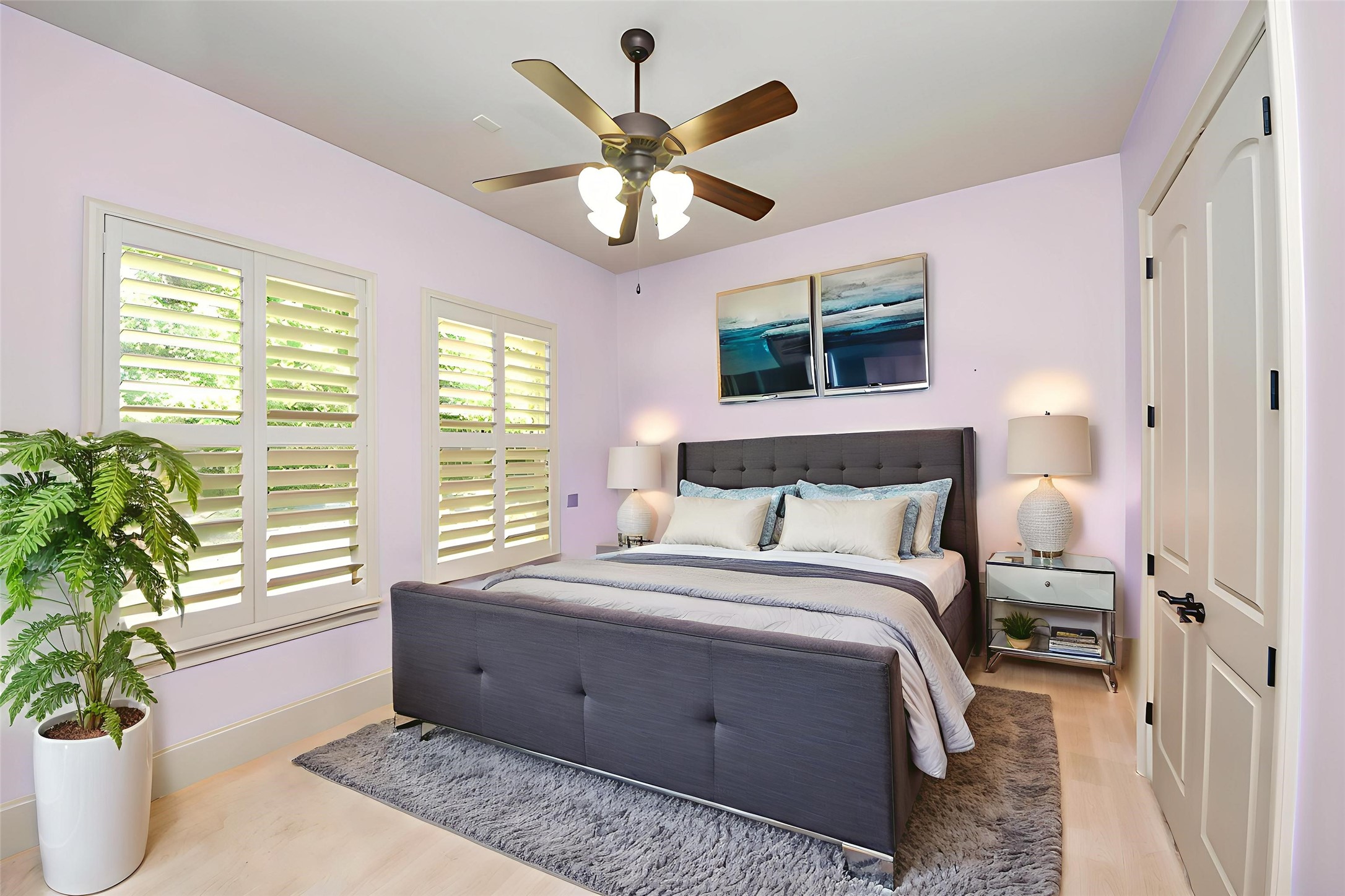 702 Fairway Oaks Conroe, TX 77302 - Photo 27 of 42 This bedroom features soft
lavender walls. It includes a
ceiling fan, ample natural light
from large platation shuttered
windows
