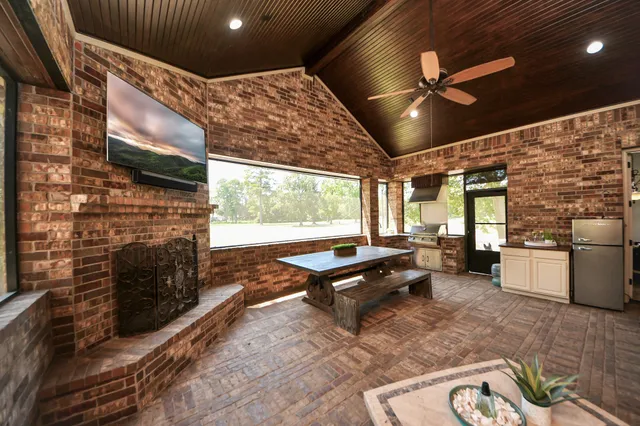a living room with furniture a fireplace and a flat screen tv