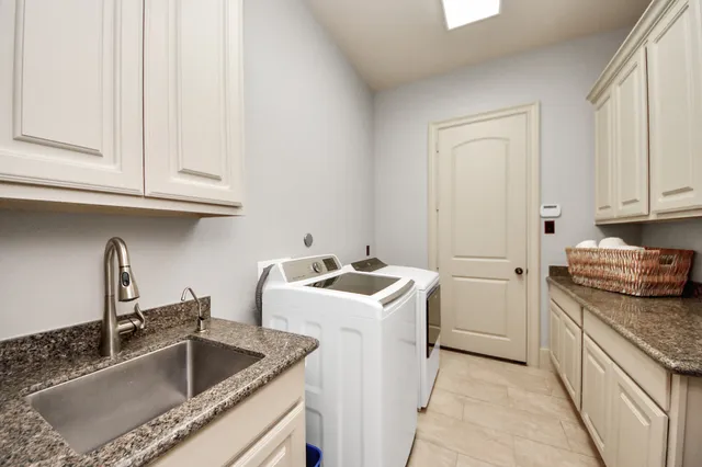 a kitchen with granite countertop a sink and a stove top oven