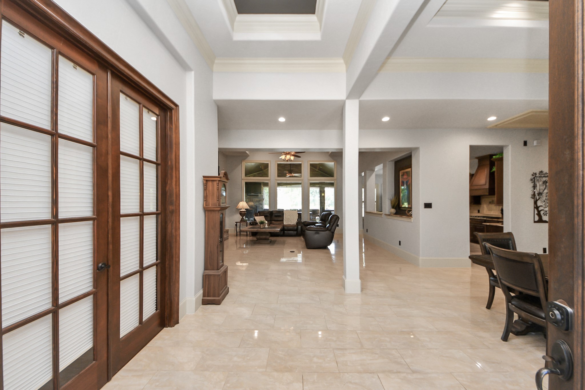 702 Fairway Oaks Conroe, TX 77302 - Photo 6 of 42 An elegant entryway leading to
an open living area. It features
high ceilings, large windows,
and polished tile floors, creating
a bright and inviting
atmosphere. The wooden
double doors and tasteful decor
add a touch of sophistication.
