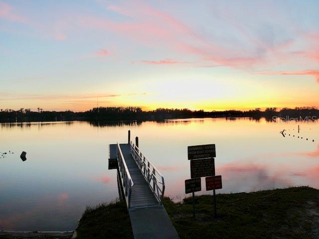 0 Purdue Street New Port Richey, FL 34654 - Photo 11 of 37 a view of a lake with table and chairs next to a large window