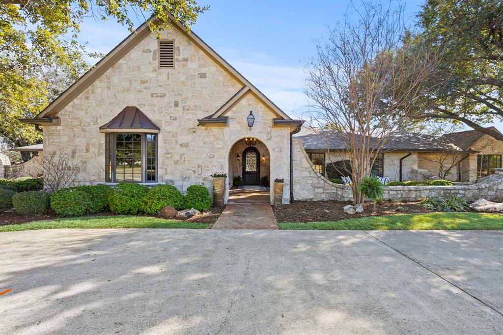 a front view of a house with garden and garage