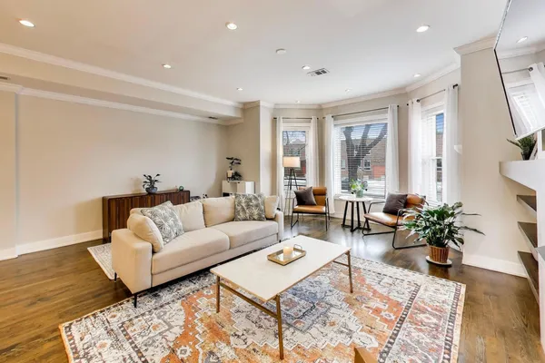 a living room with furniture potted plant and windows