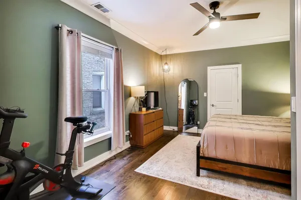a bedroom with a bed and wooden floor