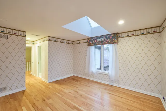an aerial view of a house with a garden and a yard