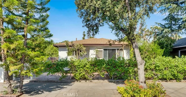 a view of a chair and table in the garden