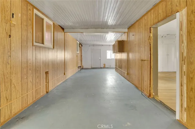 a view of a hallway with wooden shelves