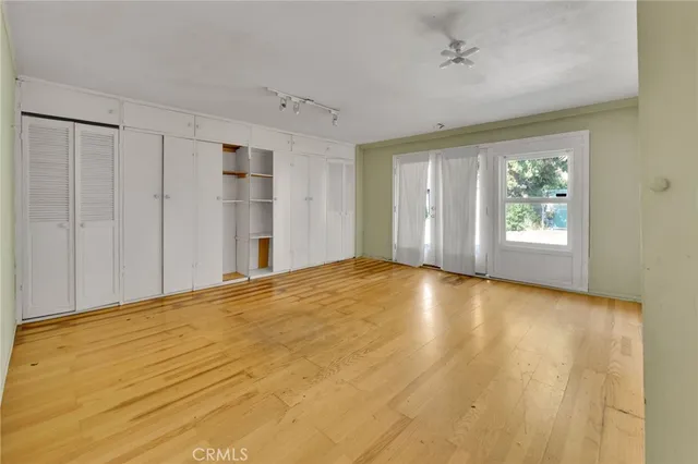 a view of an empty room with a window and fireplace