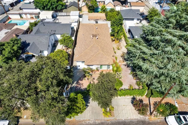 an aerial view of a house with a yard and garden