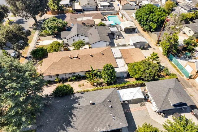 an aerial view of a house with a yard