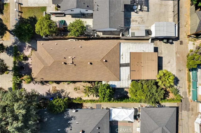 an aerial view of a house with a yard and parking