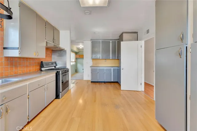 a kitchen with granite countertop a refrigerator and a sink
