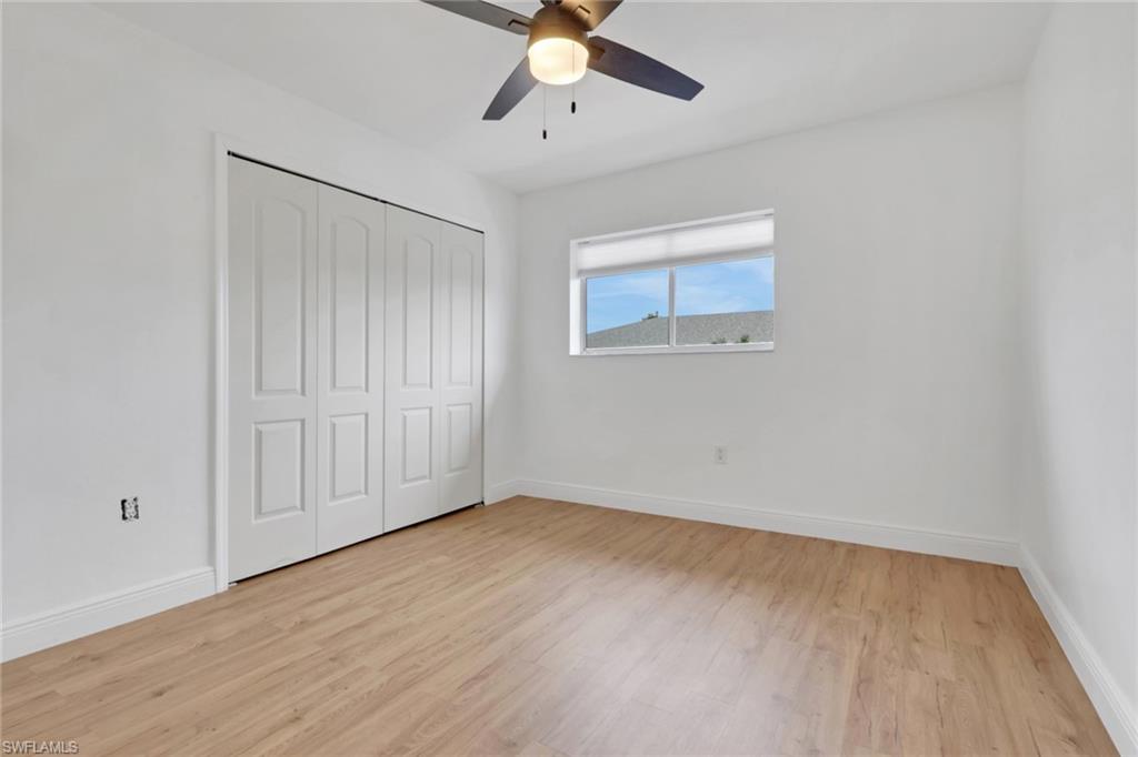 146 Cypress Way East, Unit 807 Naples, FL 34110 - Photo 21 of 27 a view of an empty room with wooden floor