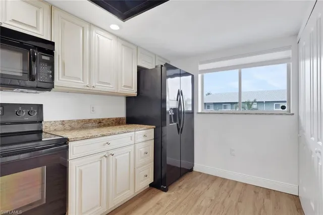 a kitchen with a refrigerator stove and microwave