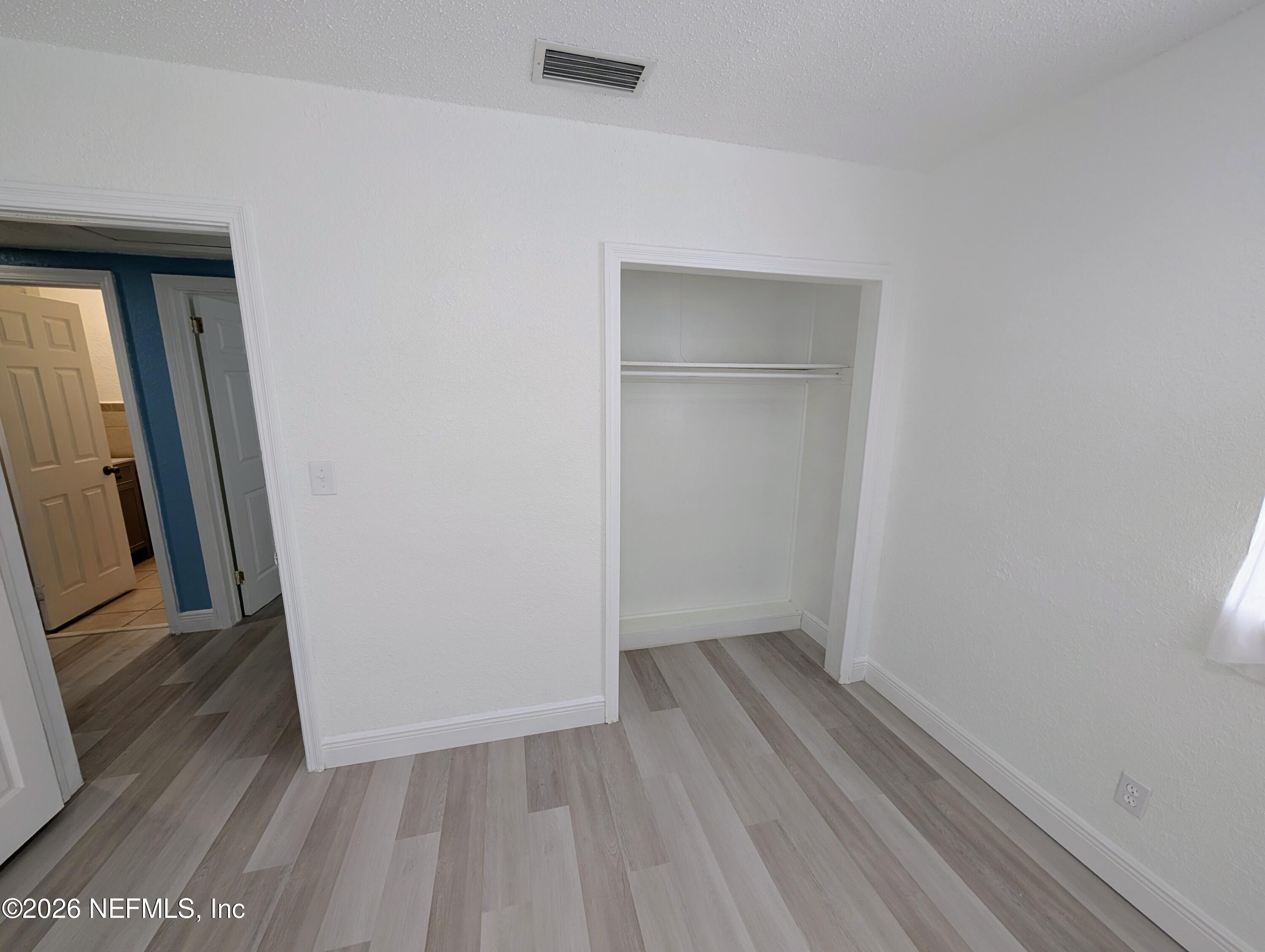 1454 Ribault Scenic Drive Jacksonville, FL 32208 - Photo 13 of 22 an empty room with wooden floor and entrance