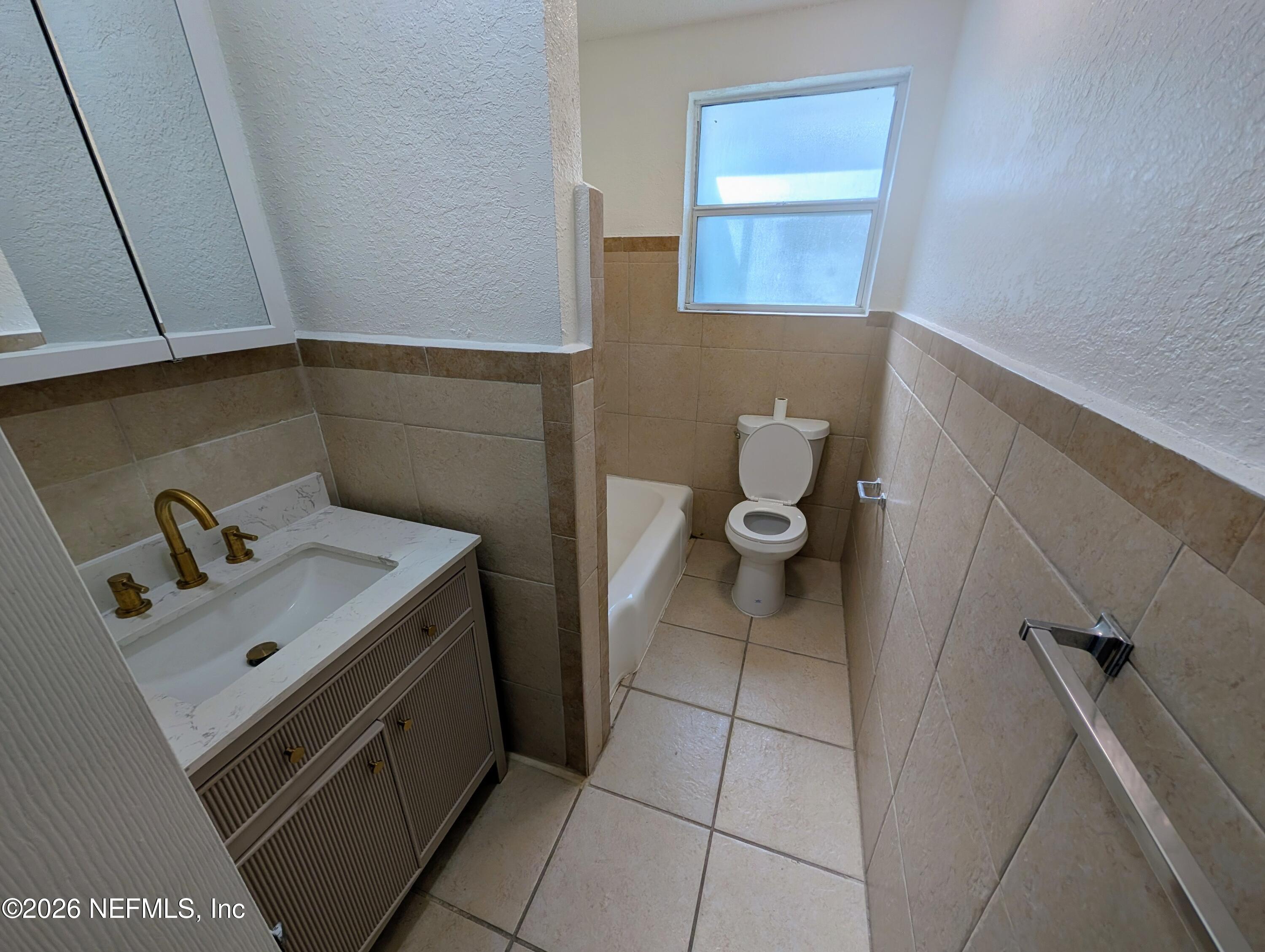 1454 Ribault Scenic Drive Jacksonville, FL 32208 - Photo 16 of 22 a bathroom with a sink and toilet