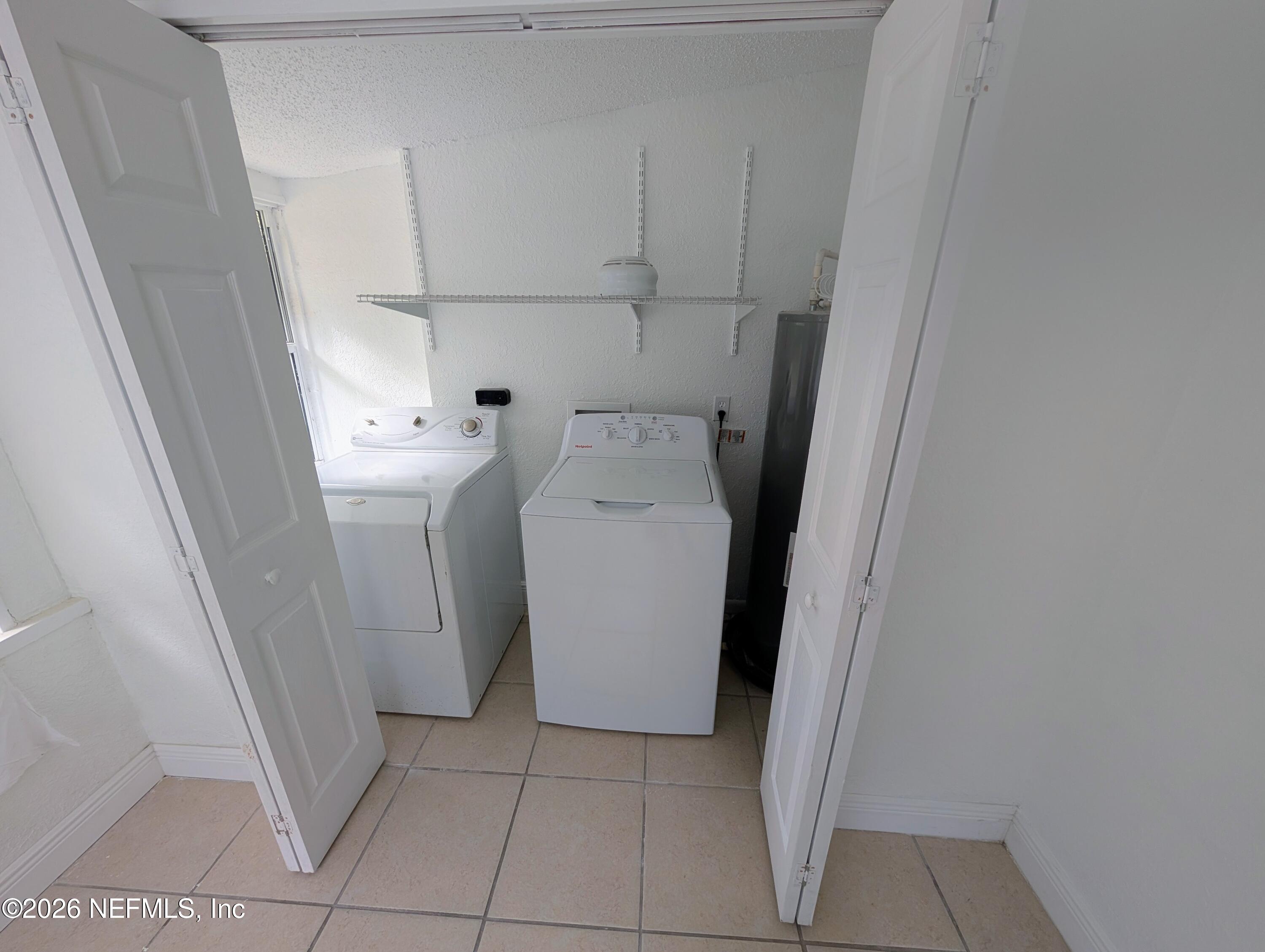 1454 Ribault Scenic Drive Jacksonville, FL 32208 - Photo 20 of 22 a utility room with dryer and washer