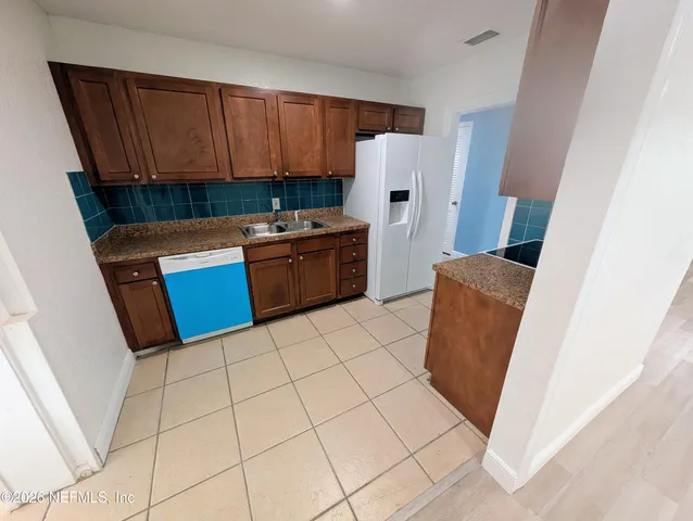 a kitchen with stainless steel appliances a refrigerator and a stove