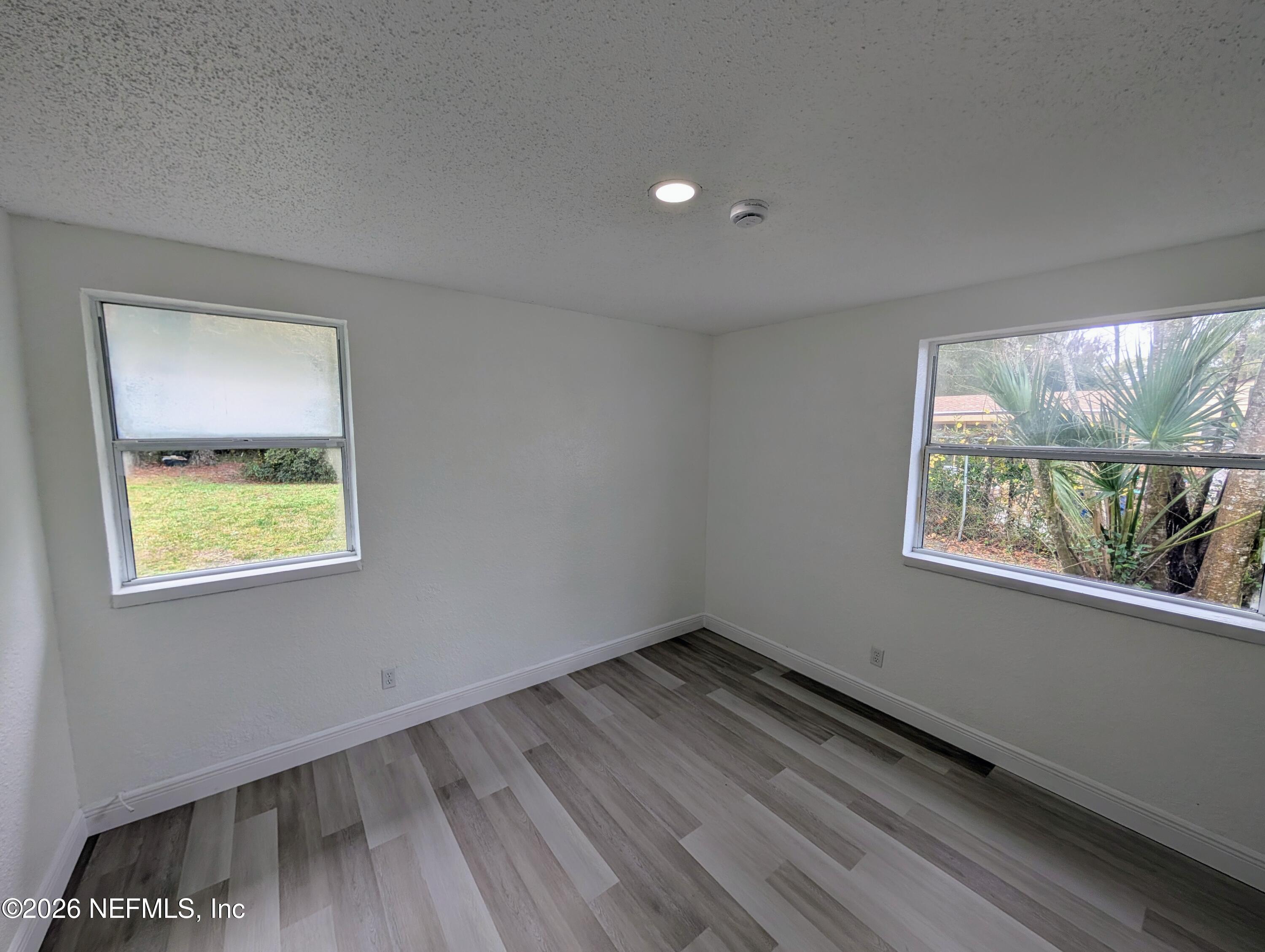 1454 Ribault Scenic Drive Jacksonville, FL 32208 - Photo 10 of 22 a view of an empty room with wooden floor and a window