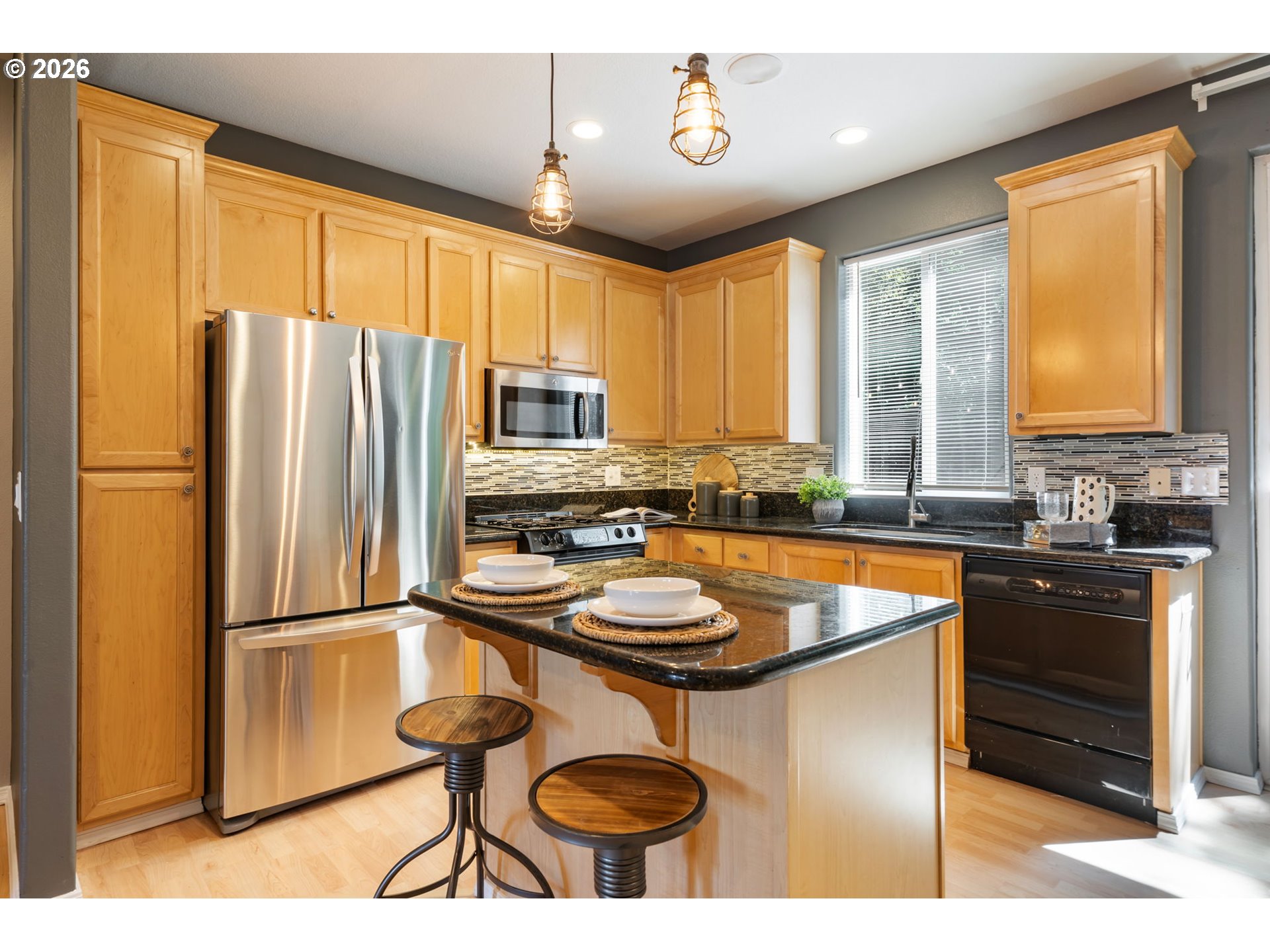 13159 Southwest Brianne Way Portland, OR 97223 - Photo 10 of 32 a kitchen with stainless steel appliances granite countertop a refrigerator a sink dishwasher a stove and a refrigerator with wooden floor