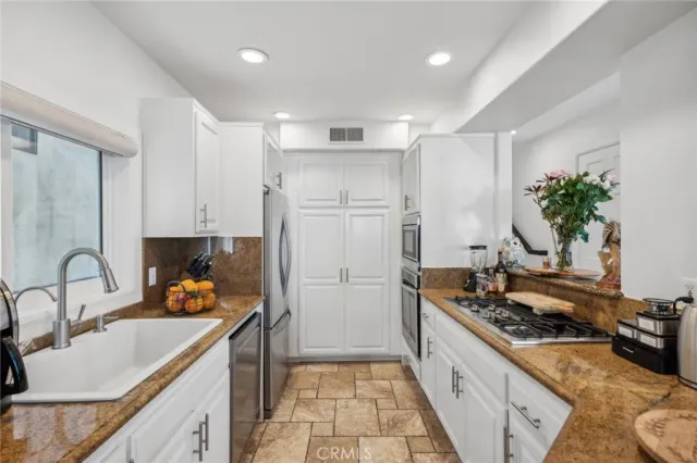 a kitchen with a sink stove and refrigerator