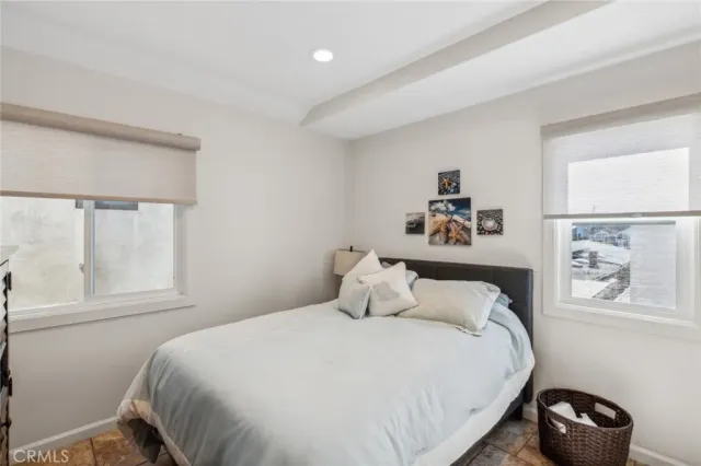 a spacious bedroom with a bed and a fireplace