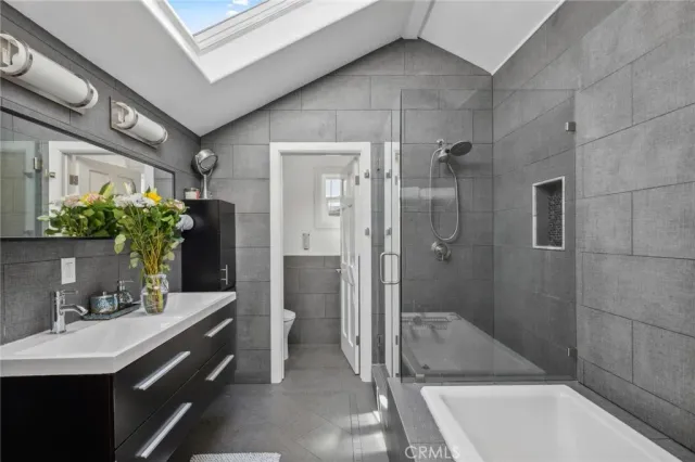 a bathroom with a double vanity sink mirror and shower