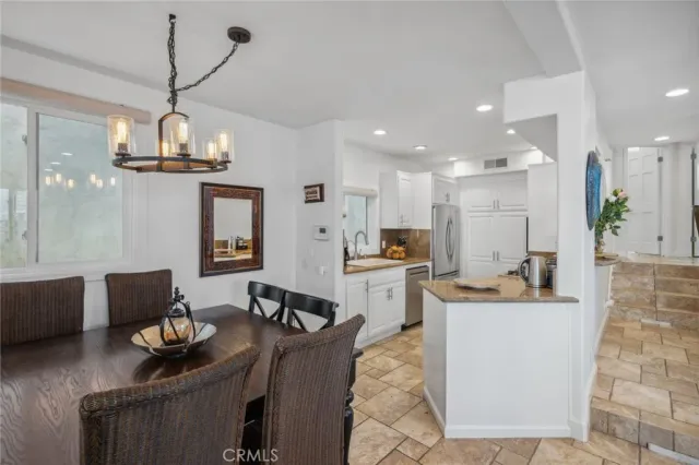 a living room with furniture a fireplace and a floor to ceiling window
