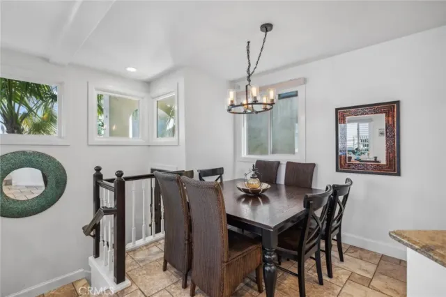 a view of a dining room with furniture and chandelier