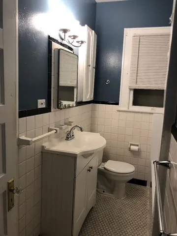 a bathroom with a sink toilet and mirror