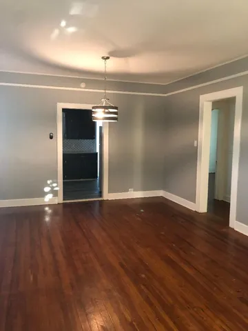 an empty room with wooden floor