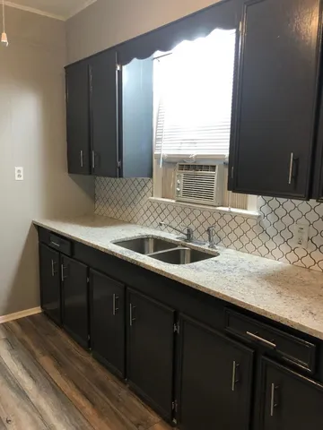 a kitchen with a sink and a window