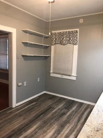 a view of a room with rack on the wall and a window