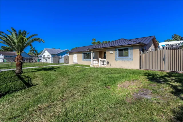a view of a house with a backyard space