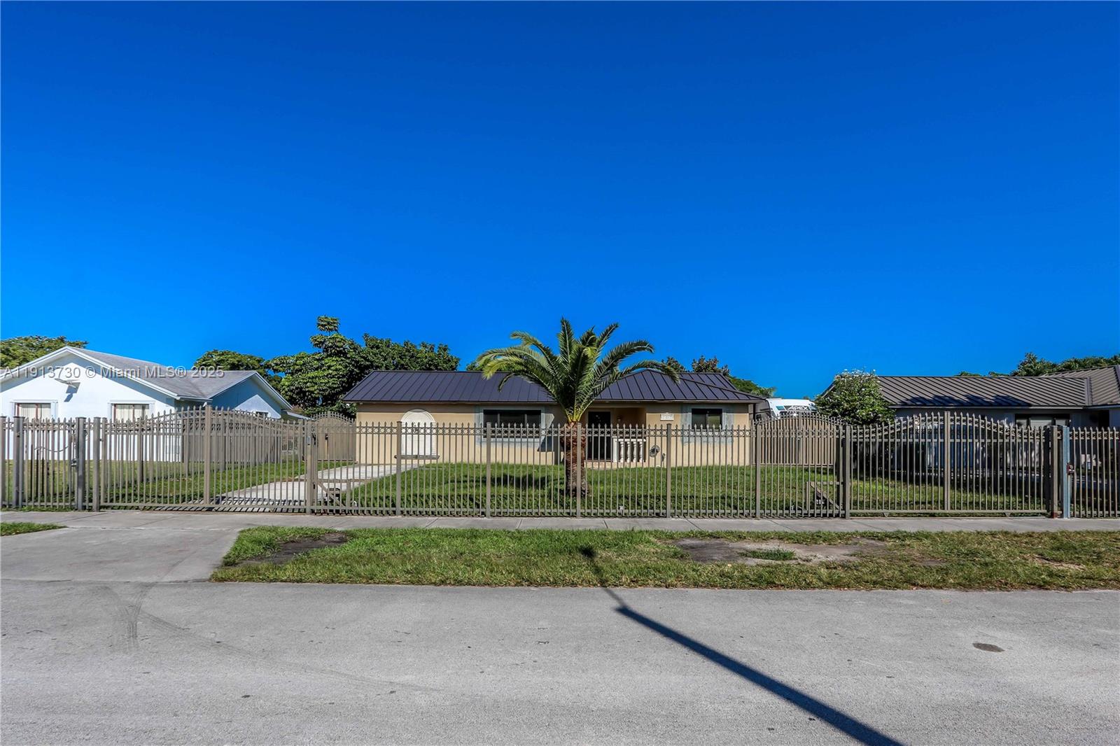 11617 Southwest 171st Street Miami, FL 33157 - Photo 2 of 23 a view of house with a big yard and potted plants
