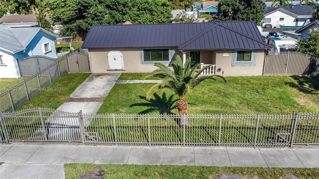 a front view of a house with plants