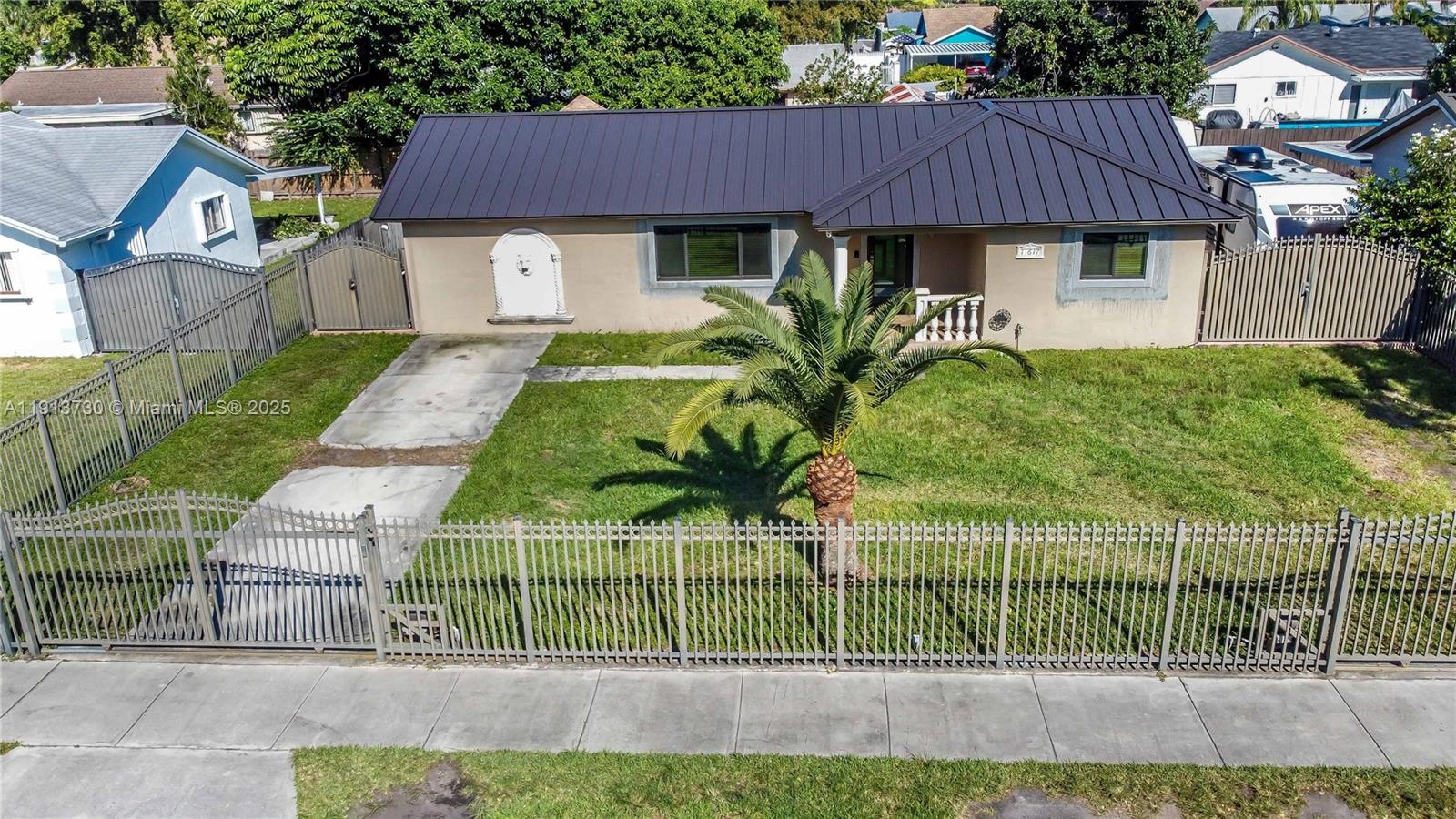 11617 Southwest 171st Street Miami, FL 33157 - Photo 3 of 23 a front view of a house with plants