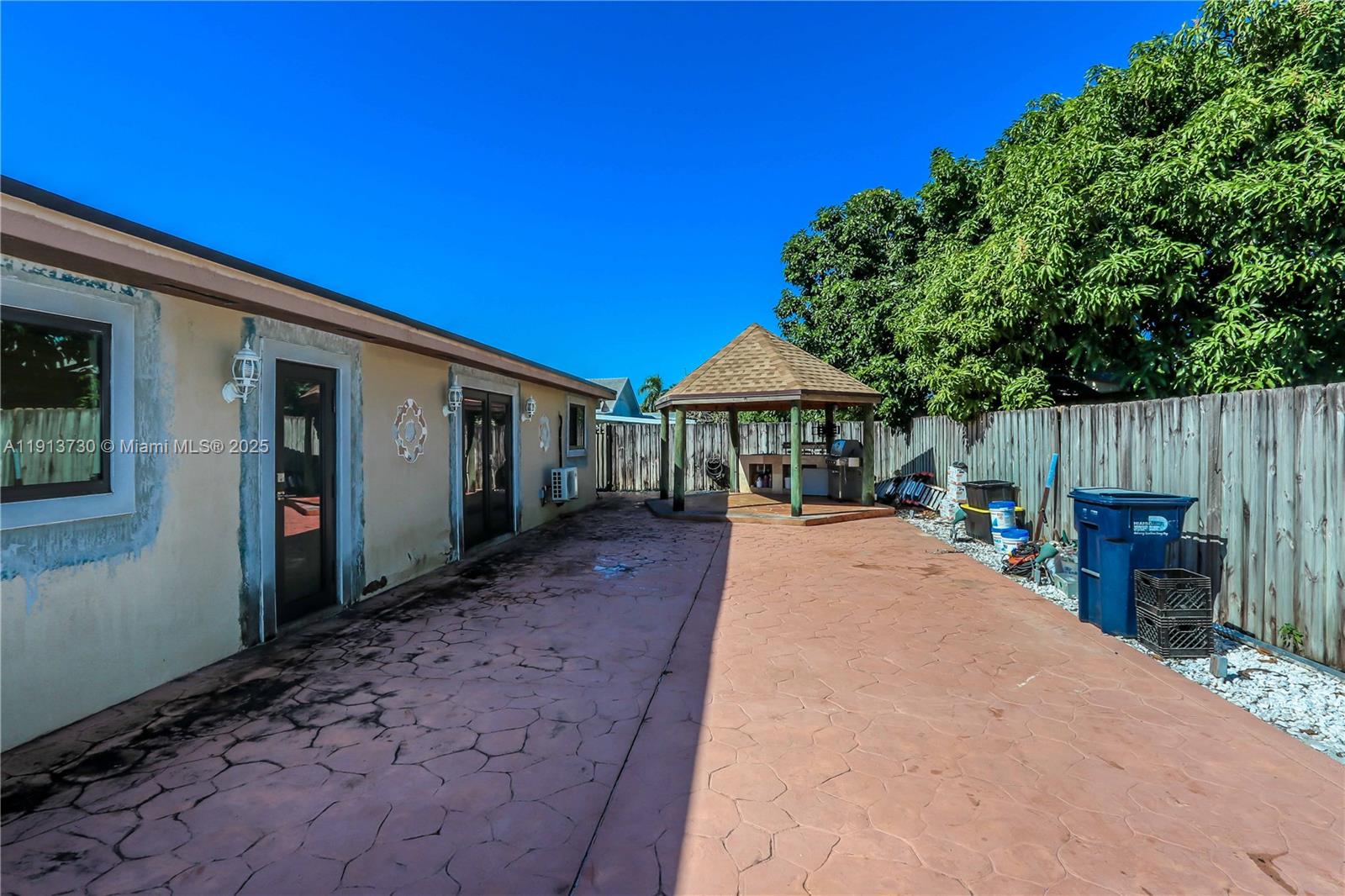11617 Southwest 171st Street Miami, FL 33157 - Photo 8 of 23 a view of house with patio outdoor seating and covered with trees