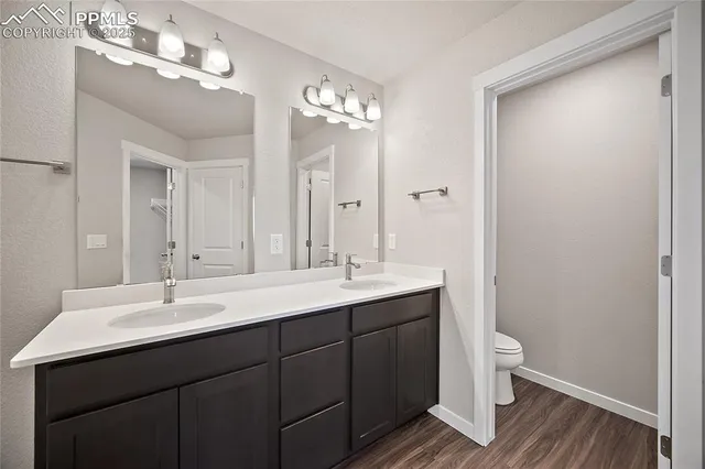 a bathroom with a double vanity sink and a mirror