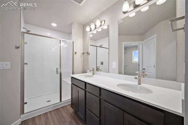 a bathroom with a sink double vanity and a shower