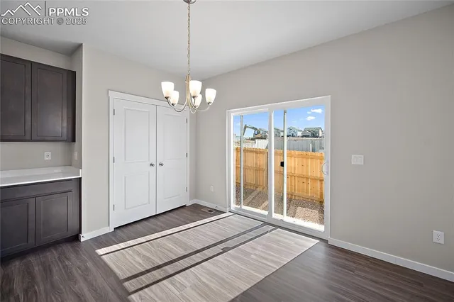 a view of a room with wooden floor and cabinet