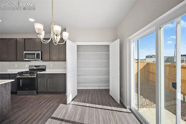 a kitchen with granite countertop wooden floors and stainless steel appliances