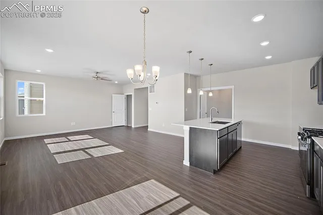 a large kitchen with sink cabinets and wooden floor