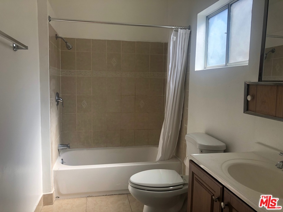 4133 Bemis Street Los Angeles, CA 90039 - Photo 8 of 13 a bathroom with a granite countertop toilet sink and bathtub