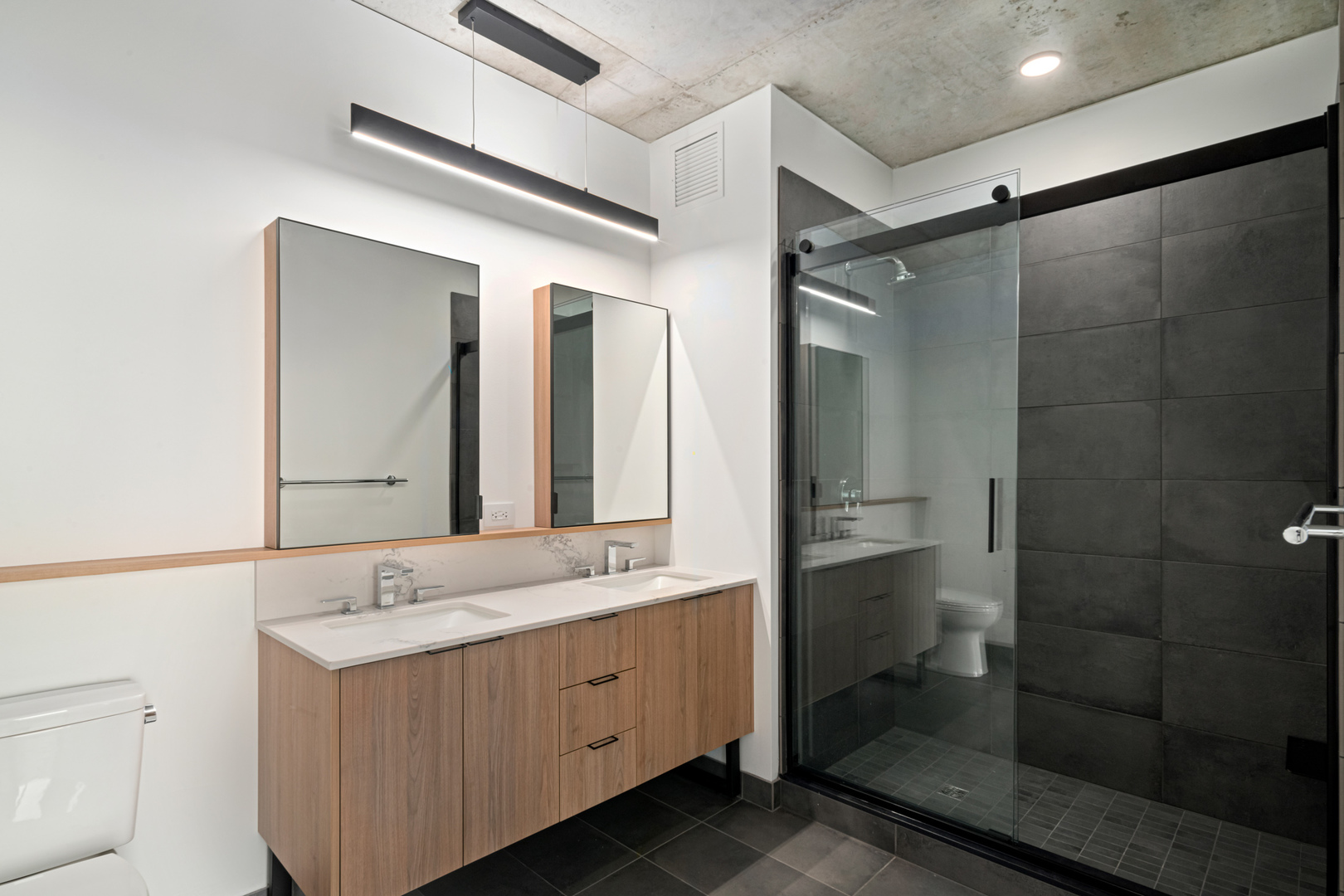 234 West Polk Street, Unit 2609 Chicago, IL 60607 - Photo 14 of 36 a bathroom with a double vanity sink mirror and shower