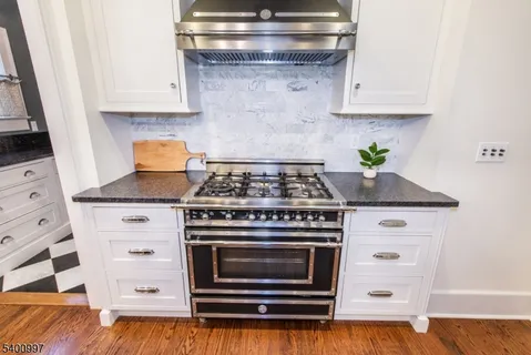 a stove top oven sitting inside of a kitchen