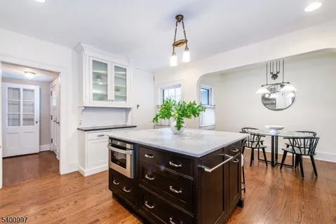 a view of kitchen and sink with wooden floor